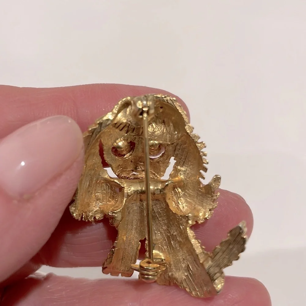 Costume puppy dog pin. Gold tone with blue crystal eyes. New.